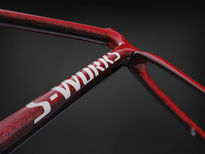 Specialized S-Works Tarmac SL9 road bike frameset in Vivid Red with Tarmac Black detailing and white S-Works graphics, shown in profile against a dark studio background