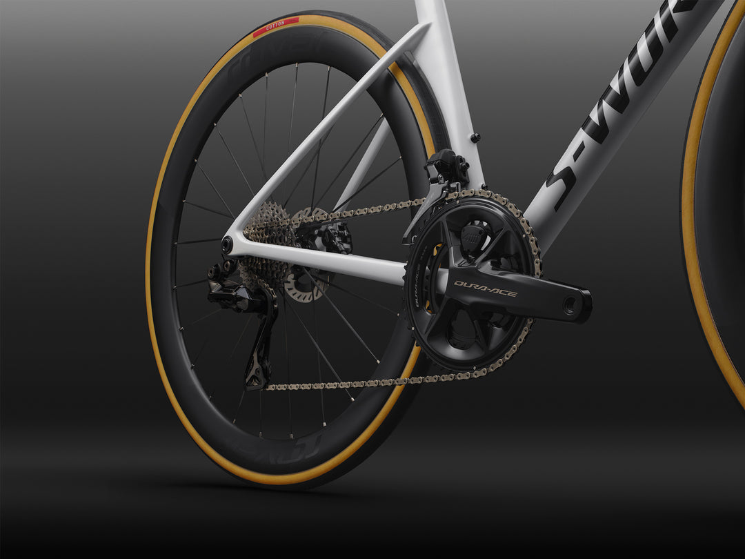 Specialized S-Works Tarmac SL9 road bike frameset in White with S-Works graphics, shown in profile against a dark studio background