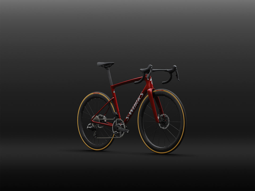 Specialized S-Works Tarmac SL9 SRAM AXS in Ruby Metallic / White Silver Metallic, shown from the front three-quarter angle against a dark studio background