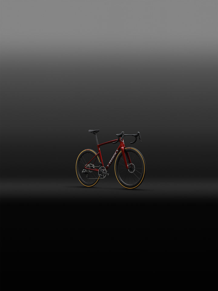 Specialized S-Works Tarmac SL9 SRAM AXS in Ruby Metallic / White Silver Metallic, shown from the front three-quarter angle in an outdoor setting