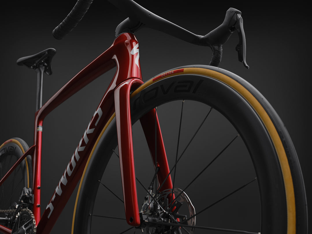 Specialized S-Works Tarmac SL9 SRAM AXS in Ruby Metallic / White Silver Metallic, medium front three-quarter detail against a dark studio background