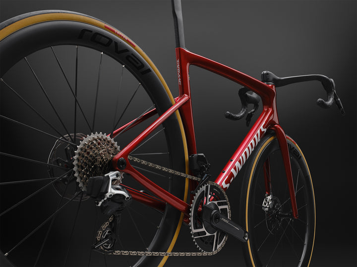 Specialized S-Works Tarmac SL9 SRAM AXS in Ruby Metallic / White Silver Metallic, medium rear three-quarter detail against a dark studio background