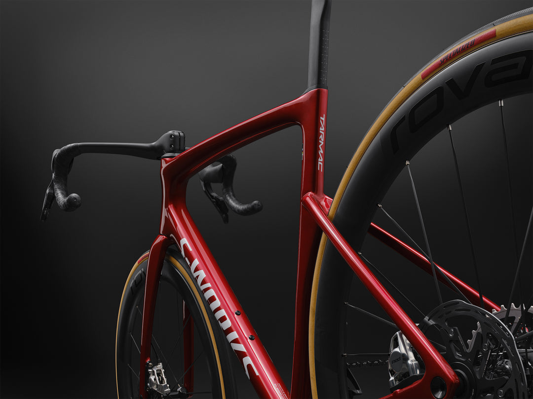 Specialized S-Works Tarmac SL9 SRAM AXS in Ruby Metallic / White Silver Metallic, non-drive-side rear three-quarter detail against a dark studio background