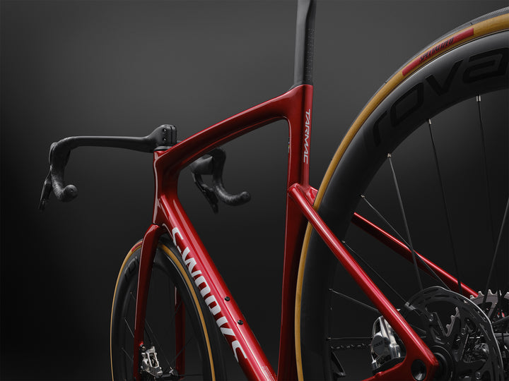 Specialized S-Works Tarmac SL9 SRAM AXS in Ruby Metallic / White Silver Metallic, non-drive-side rear three-quarter detail against a dark studio background