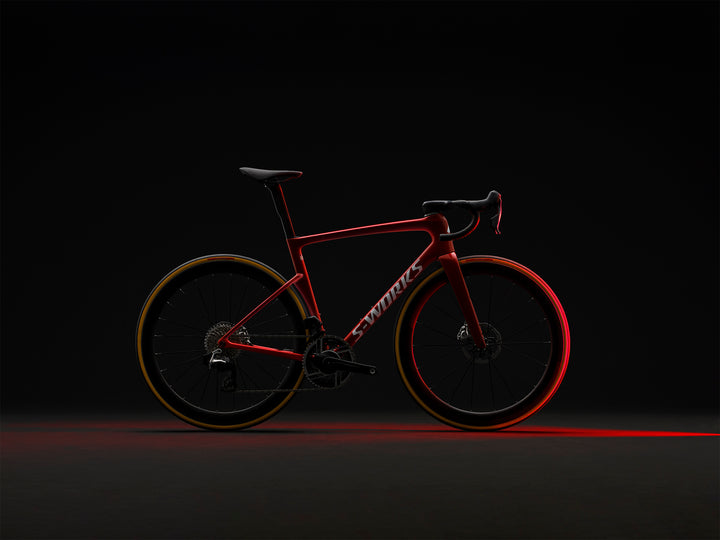 Specialized S-Works Tarmac SL9 SRAM AXS in Ruby Metallic / White Silver Metallic, alternate profile view against a dark background