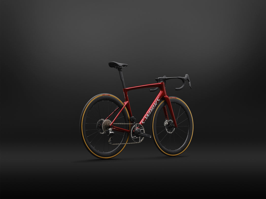Specialized S-Works Tarmac SL9 SRAM AXS in Ruby Metallic / White Silver Metallic, shown from the rear three-quarter angle against a dark studio background
