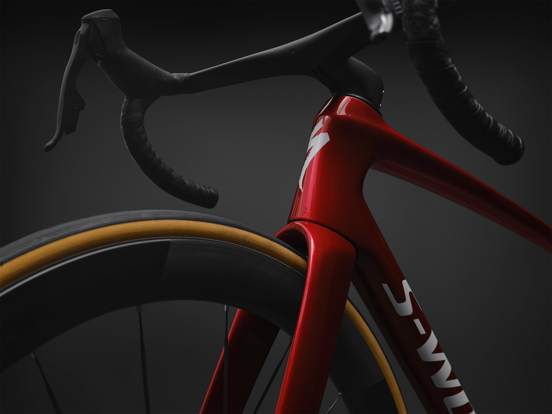 Specialized S-Works Tarmac SL9 SRAM AXS Speed Sniffer downtube detail in Ruby Metallic, shown against a dark studio background