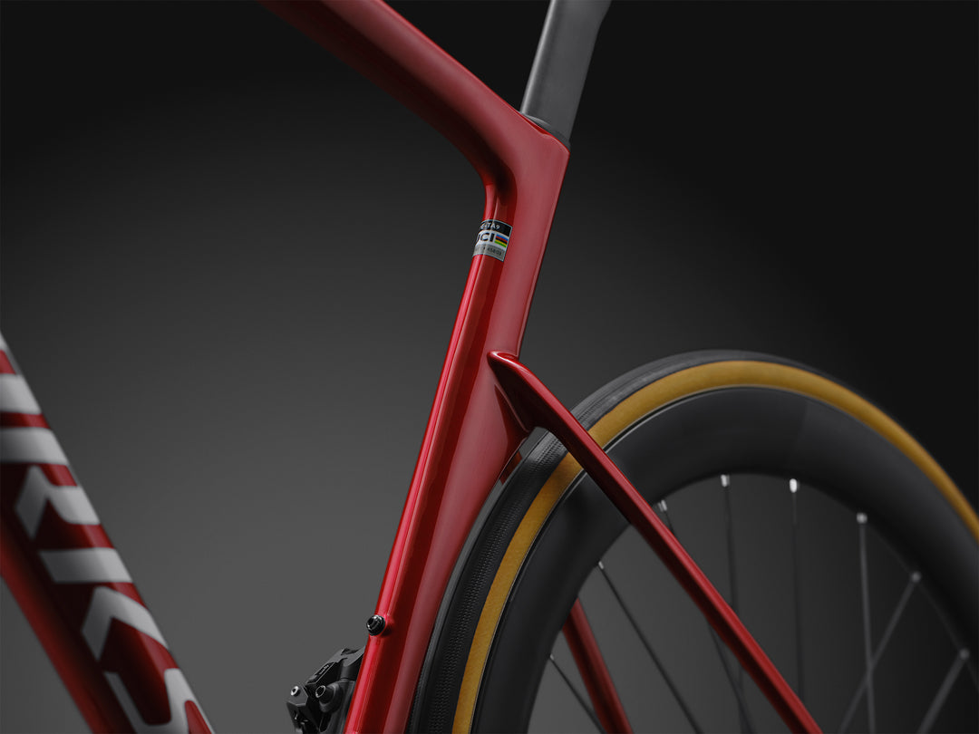 Specialized S-Works Tarmac SL9 SRAM AXS Win Fin aero seat tube detail in Ruby Metallic, shown against a dark studio background