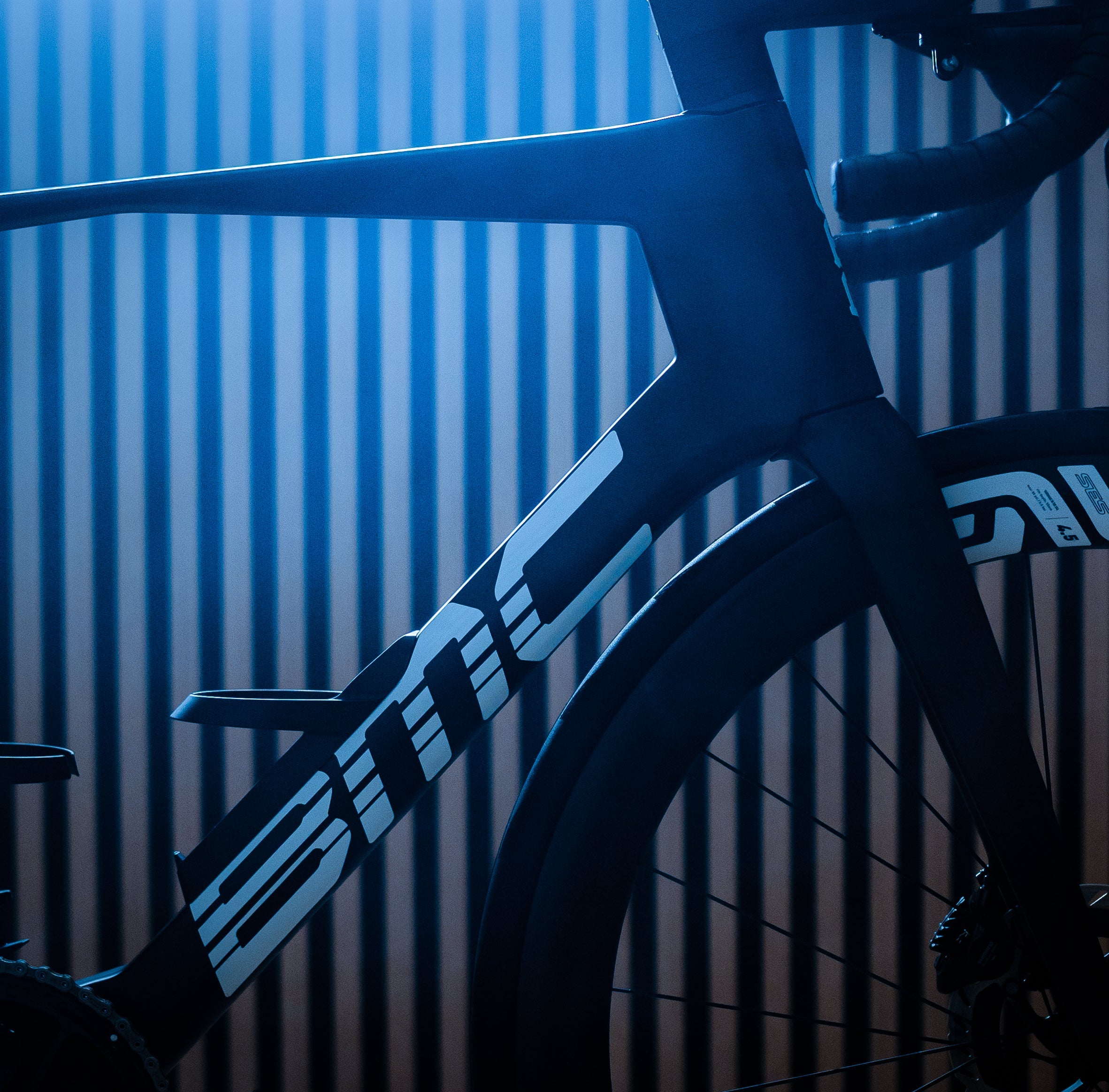 Bicycle frame with 'BMC' branding against a striped background