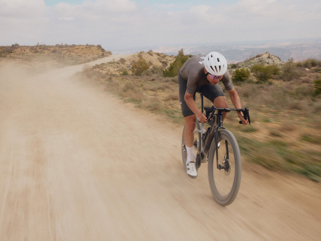 Rider racing the Argon 18 Anti Matter on a dusty gravel road