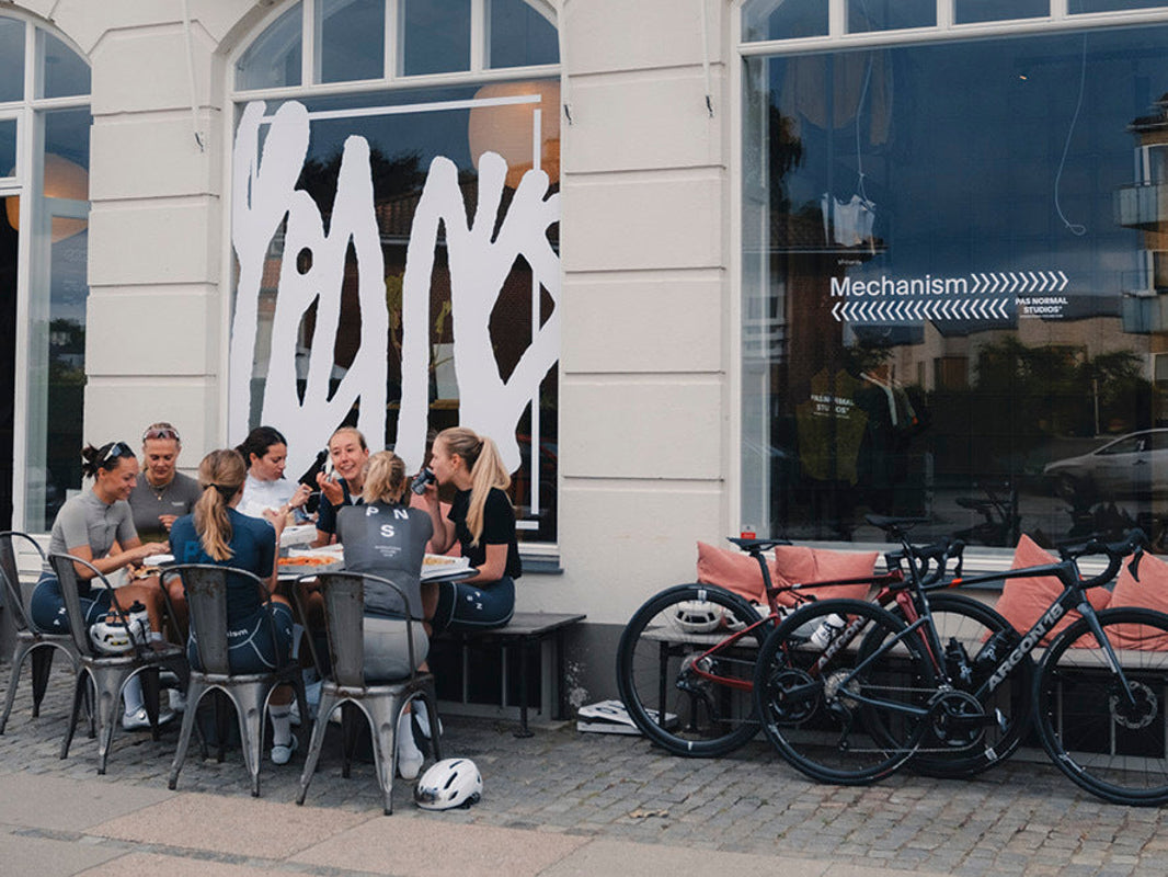 Riders with Argon 18 Equation bikes outside a café