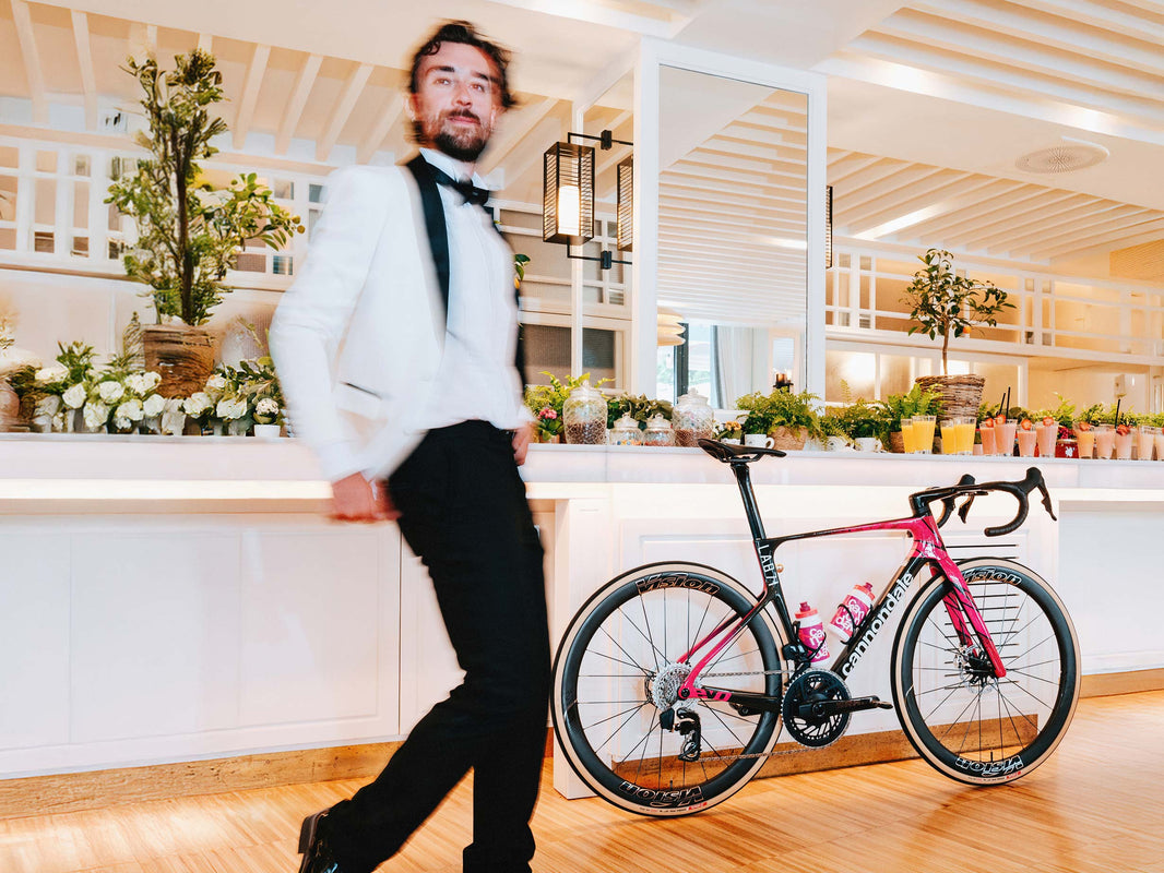 Rider walking a Cannondale SuperSix EVO through a bright dining room