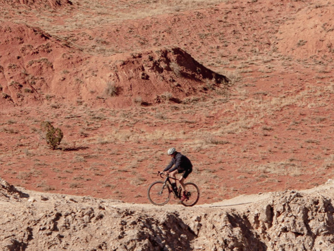 Cannondale Topstone rider crossing red desert terrain